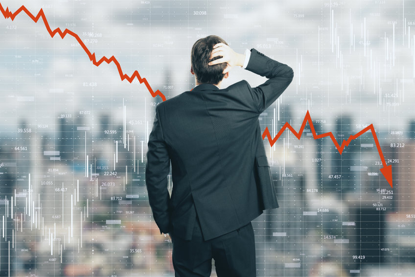 Back view of stressed young businessman looking at downward red arrow on blurry city background. Decrease, stats and economy concept. Multiexposure