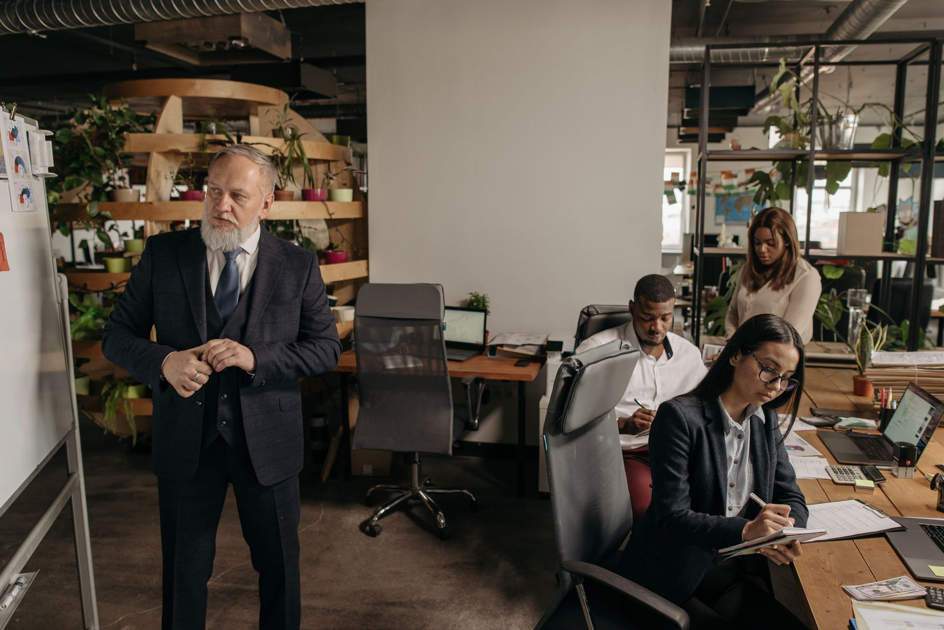 An employee receiving a promotion handshake from a manager in an office setting