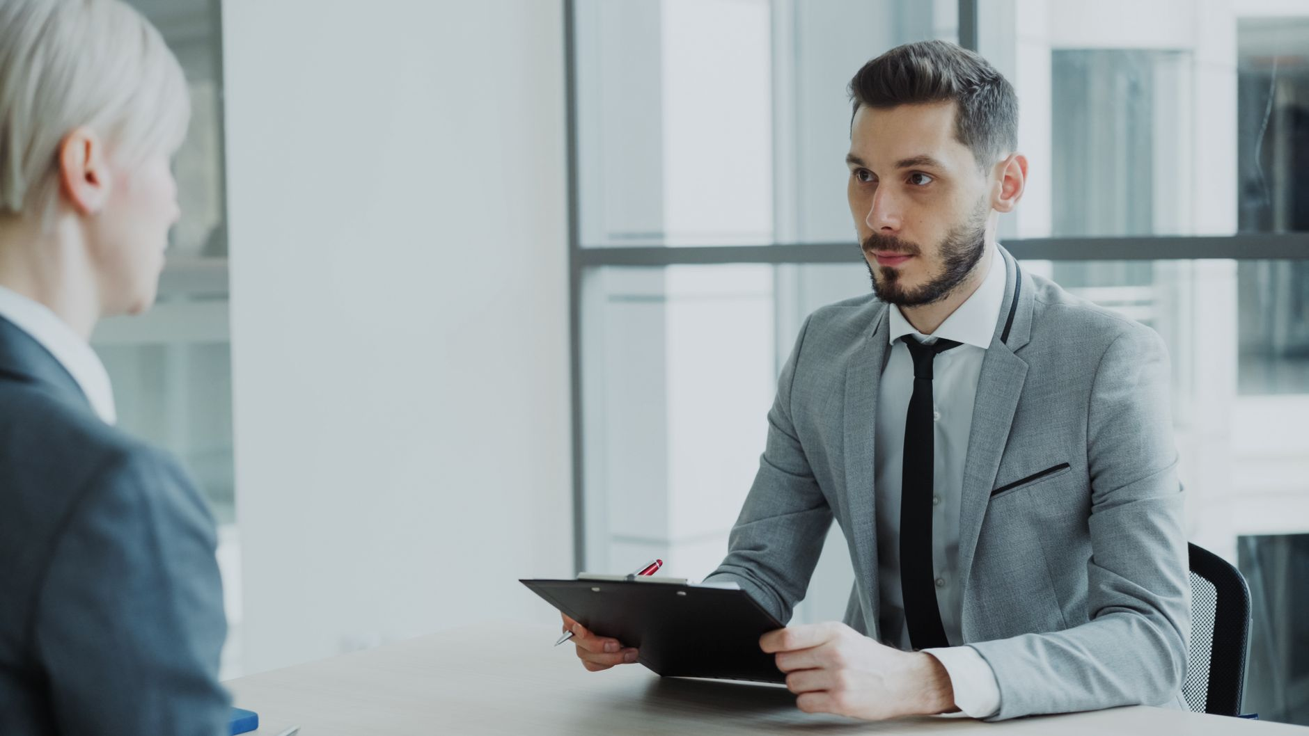 A manager receiving candid feedback from a colleague in an open office setting